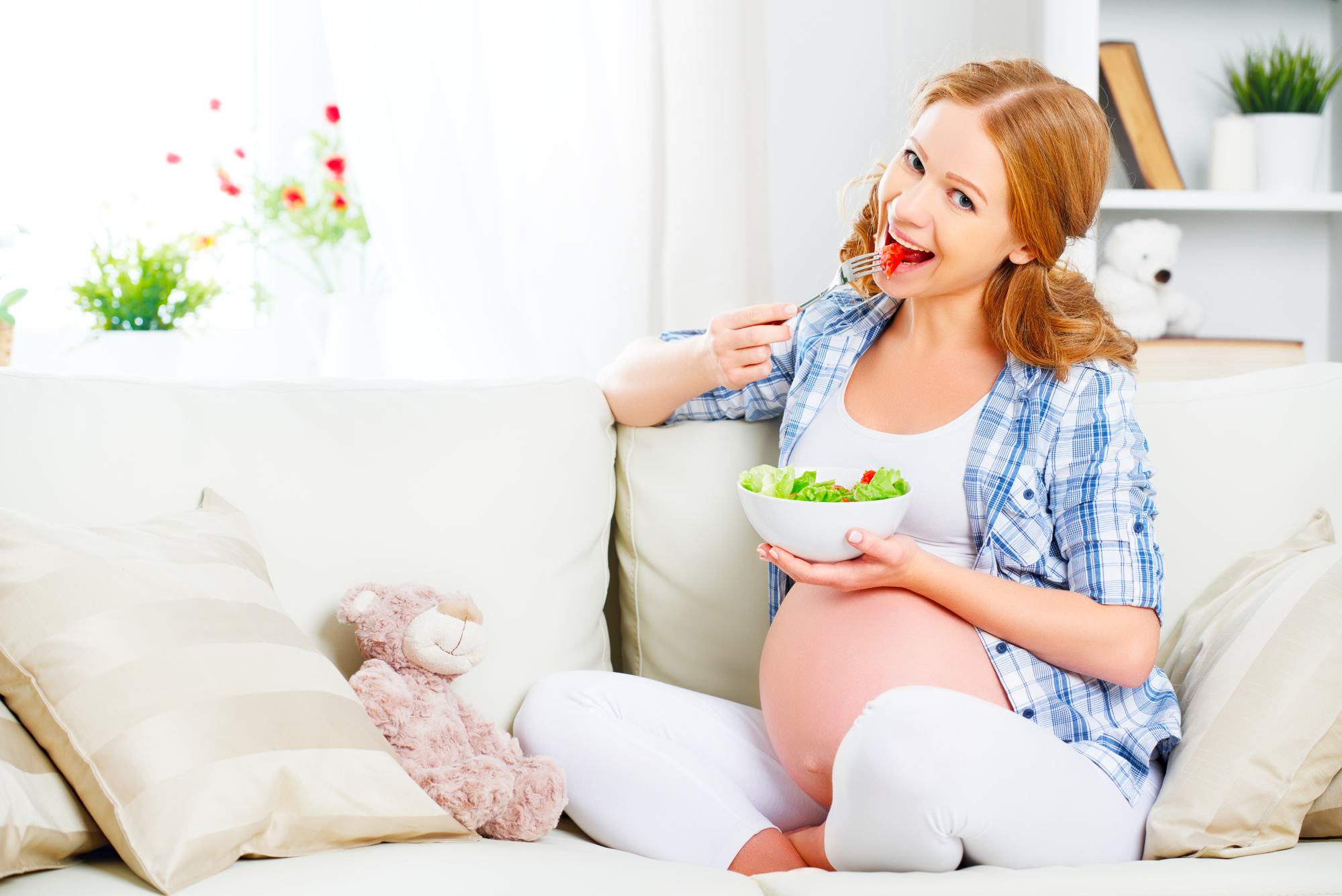 happy pregnant woman eats healthy food vegetable salad