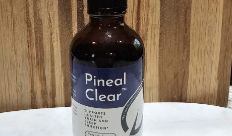 Dropper bottle of Pineal Clear supplement on table.