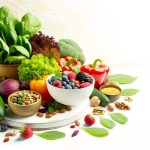 Assorted fresh vegetables, fruits, nuts, and legumes display.